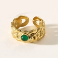 Vintage gold twist ring featuring a round green stone and classic adjustable band - Green