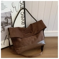 Detail of vintage brown suede tote bag featuring braided handles and durable leather base - Brown