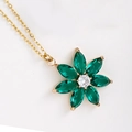 Golden flower pendant necklace featuring emerald green marquise crystals and a white center stone - Large Floral