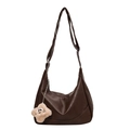 Brown faux leather hobo bag with adjustable strap and plush star charm on white background - Brown