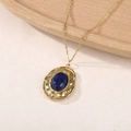 Detailed close-up of blue natural stone pendant with hammered gold-plated texture - Lapis Lazuli