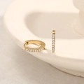 Gold plated huggie earrings with a single row of zircon stones on white tray - Round Thin Single Layer Zirconia Huggie / Medium