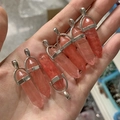 Detailed view of pink crystal hexagonal column pendants with wire wrapped silver loops - Watermelon red