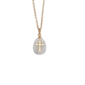 Macro detail of natural stone drop pendant with golden cross inlay and sleek metal chain - Grey/Marble Texture
