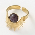 Detailed view of gold sunburst ring featuring a round purple gemstone and textured rays - Purple