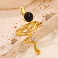 Snake shape gold ring with natural black stone and white zircon on travertine stone - Black Style