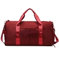 Large burgundy travel bag with water-resistant fabric and adjustable shoulder strap - Red