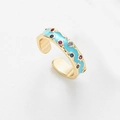 Anello aperto dorato con smalto celeste e zirconi colorati dal design a onde raffinato - Celeste