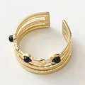 Detail of adjustable gold layered ring featuring a wave texture and black beads - Gold with Black Gemstone