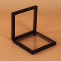 Black 3D floating jewelry display frame with elastic PE film in an open position - 9x9 / Black