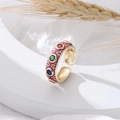 Adjustable gold open ring with colorful gemstones and heart pattern on a minimalist tray - Purple