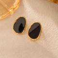 French vintage oval gold rimmed black enamel stud earrings on a beige textured background - Irregular Stud Earrings Pair - Black
