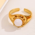 Gold adjustable stainless steel ring featuring a round white natural stone inlay - White