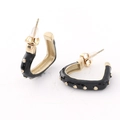 Detailed macro view of black enamel hoop earrings with gold rivet stud accents and secure backs - Black Enamel Gold Rivet Style