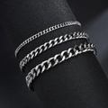 Detailed view of three polished silver stainless steel curb chain bracelets on a stand - Steel - 3mm Width - Bracelet 18+5cm