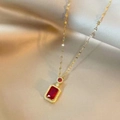 Elegant gold chain necklace featuring a large emerald-cut red gemstone and diamond halo - Red Gemstone Necklace
