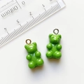 Green resin gummy bear pendants with gold and silver metal rings and size reference - Green