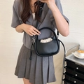 Minimalist black crescent crossbody handbag with a chic integrated round handle and drawstring - Black