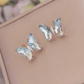 Detail shot of gradient blue crystal butterfly stud earrings with rose gold base - 925 Silver Pin Butterfly Studs / Light Blue