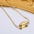 Elegant gold snake chain necklace with a polished bean pendant shown on a mirror surface - Oval Bean Pendant (A4983)
