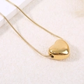 Polished heart pendant on a gold snake chain necklace displayed on a marble surface - Heart Pendant (A4985)