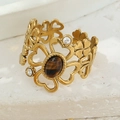 Macro view of gold flower ring with cat eye stone inlay and hollow clover design - Brown (Tiger's Eye Style)