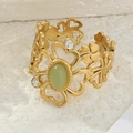 Macro shot of gold floral ring with green cat eye stone and small diamonds on stone base - Green (Cat's Eye Style)