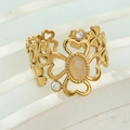 Detail of gold floral hollow ring featuring opal stone and sparkling zircon accents - Pink (Opal Effect Style)