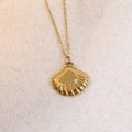 Macro detail of golden seashell pendant with radial texture and sparkling zircon inlay - Scallop with Zircon