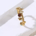 Detalle de anillo dorado ajustable con motivos de mariposa y gema esférica marrón - Marrón
