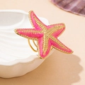 Detail of pink starfish napkin ring with golden accents on a shell tray decor - One Size / Pink