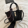 Black pebbled leather bucket bag with gold twist lock and polka dot scarf handle - Black