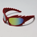 Close-up of Y2K wraparound sunglasses with red flame-shaped frame and gradient lenses - Red Frame Gold Lenses