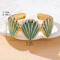 Gold open shell cuff bracelet with turquoise enamel details in a 5.7cm width size - Blue