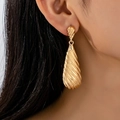 Elegant large gold teardrop dangle earrings with a textured diagonal embossed finish - Gold
