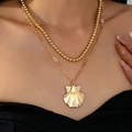 Collana doppia dorata con catena a sfere, maglie a graffetta e ciondolo a conchiglia - Giallo Oro