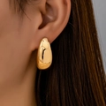 Elegant gold-tone teardrop stud earrings with a polished mirror finish for women - Gold