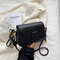Classic black leather crossbody bag with gold hardware and elegant flap closure design - Black