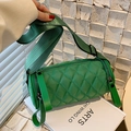Green quilted cylinder crossbody bag with wide woven strap and double zipper closure - Green