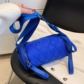 Quilted nylon cylinder crossbody bag in royal blue with wide strap and zip detail - Blue