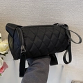 Black quilted cylinder crossbody bag in durable nylon with wide adjustable shoulder strap - Black