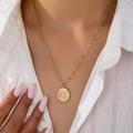 Golden sunburst face pendant necklace with delicate chain on a striped white shirt - Gold Yellow