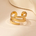 Detailed view of multilayer golden spiral ring with minimalist hollow geometric design - Gold