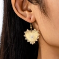 Elegant gold heart earrings with sunburst texture and zircon center worn by model - Gold with Rhinestone Drop Earrings