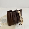 Dark brown woven tote bag with contrast stitching and branded ribbon on textured fabric - Coffee