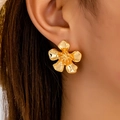 Elegant gold five-petal flower stud earrings with a polished finish worn on the ear - Gold Yellow