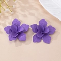 Detailed view of elegant purple petal earrings with a matte finish on a beige background - Purple