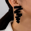 Fashionable black geometric tiered earrings with asymmetrical rectangles on female model - Black
