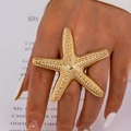 Exaggerated golden starfish ring for women with textured metal finish on hand - One Size / Gold