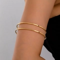Close-up of minimalist double-line golden arm cuff with a polished metallic finish - Gold Yellow